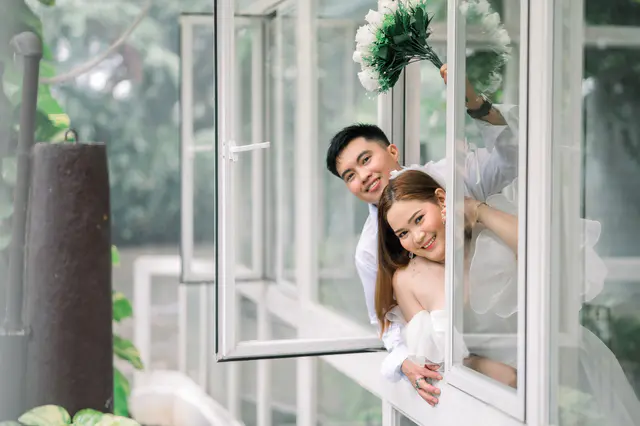 Family of four together at the stone archway during a shoot at Jardin